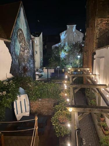 a building with a painting on the side of it at night at 55 High Street in Hastings