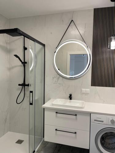 a bathroom with a sink and a mirror at Moris Boutique Beach Hotel in Gdańsk