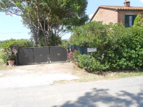 una valla negra delante de una casa en CASA INDIPENDENTE con giardino-min 3 notti, en Castiglione del Lago