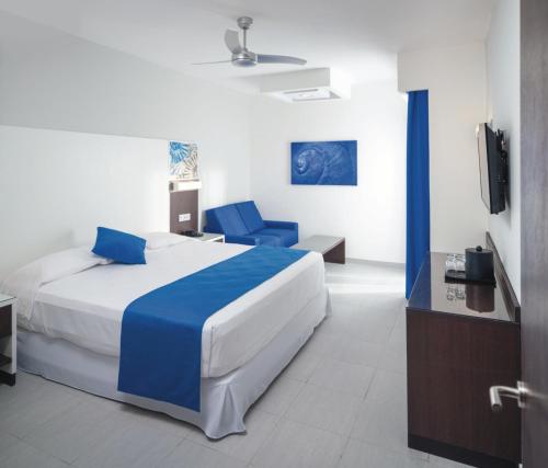 a hotel room with a bed and a tv at Riu Reggae - Adults Only - All Inclusive in Montego Bay