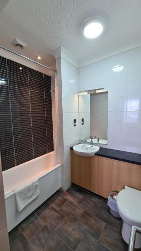 a bathroom with a sink and a toilet and a mirror at The Royal Hotel in Liverpool