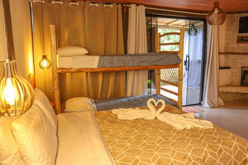 a bedroom with two bunk beds and a window at Hotel da Inês in Visconde De Maua