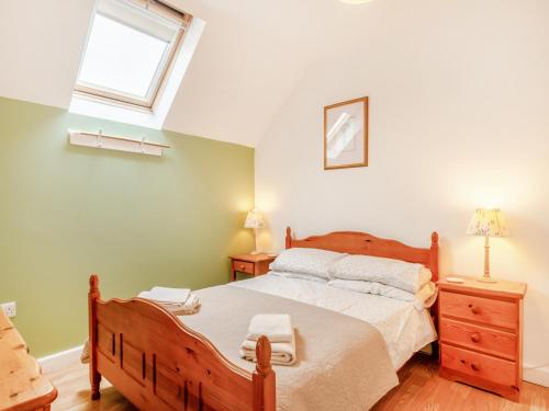 a bedroom with a large bed and a window at The Granary - Uk43951 in Boosbeck