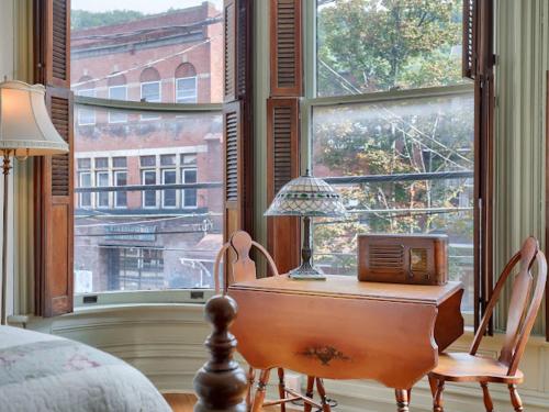 a bedroom with a desk with a radio and a window at Shamokin Bed and Breakfast in Shamokin