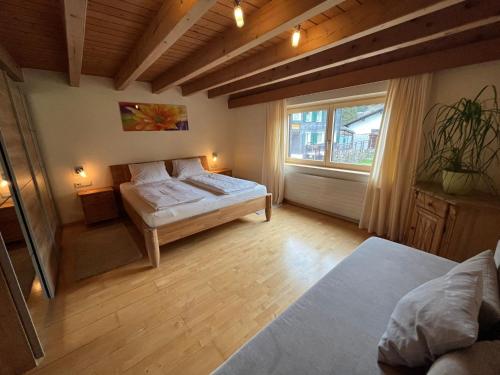 een grote kamer met een bed en een raam bij Seppl Stoba in Schruns
