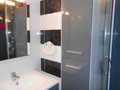 une salle de bain avec un lavabo, une douche et un miroir dans l'établissement T2 + mezzanine avec balcon, parking privatif à Saint-Hilaire-de-Riez - FR-1-324-447, à Saint-Hilaire-de-Riez