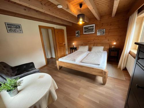 a bedroom with a bed and a couch and a table at Seppl Stoba in Schruns-Tschagguns