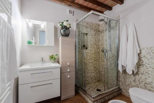 a bathroom with a shower and a sink at Helene Smart Flat with Elevator inside Lucca in Lucca
