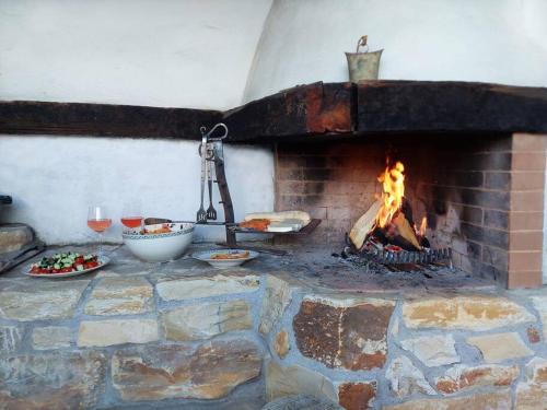 a brick oven with food and a fire in it at HERZLI-CHALET über dem Rheintal mit Schlossblick in Werdenberg