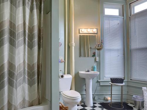 a bathroom with a toilet and a sink at Shamokin Bed and Breakfast in Shamokin