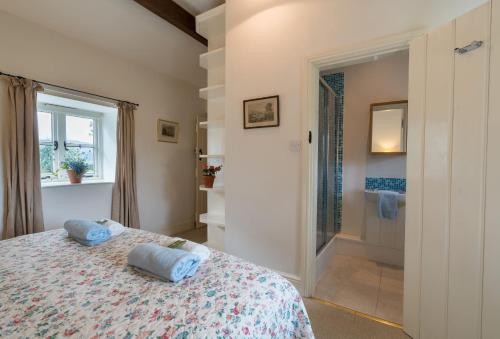 a bedroom with a bed with blue pillows on it at Ty Newydd in Tal-y-Cafn