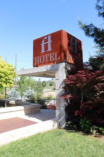 a sign for a hotel sitting in the grass at FH Hotel Rural in Felgueiras