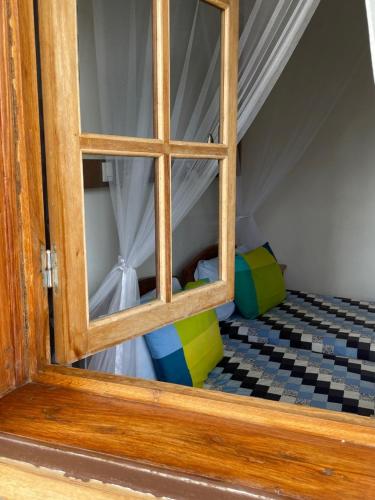 an open door of a bunk bed with a window at Hotel Ambalakely in Ambalakely