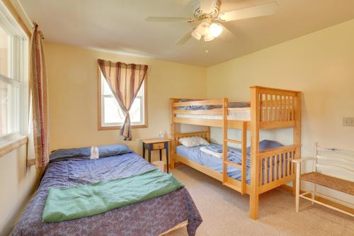 a bedroom with two bunk beds and a ceiling fan at Spacious Jay Peak Vacation Rental with Mountain View in Jay