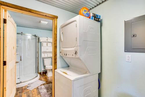 a white refrigerator in a bathroom with a shower at Northeast Texas Vacation Rental about 6 Mi to Commerce in Commerce