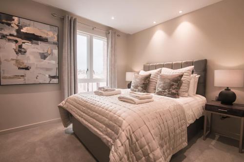 a bedroom with a bed with towels on it at Entire 2 Bed - No. 49 - The Cosy Collection Ltd in York
