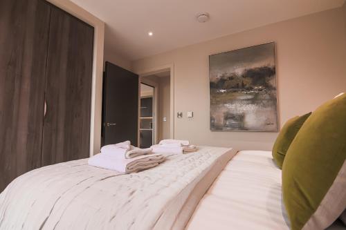 a bedroom with a bed with towels on it at Entire 2 Bed - No. 49 - The Cosy Collection Ltd in York