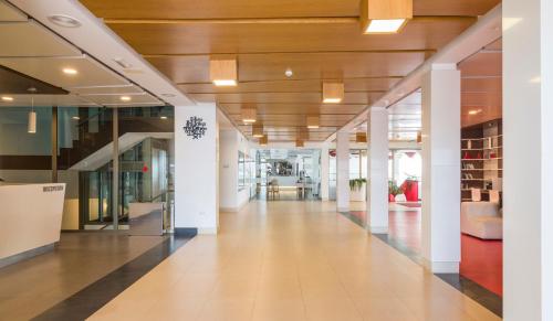 a hallway of an office building with white columns at ILUNION Costa Sal Lanzarote in Puerto del Carmen