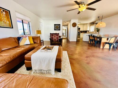 a living room with a couch and a table at Ravens Nest Ranch, Fire pit , Views, Near JT Park! in Joshua Tree