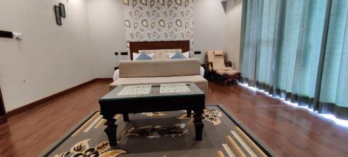 a living room with a piano and a chair at DreamCatcher By Samyati Hotels and Resorts in Bhīm Tāl