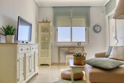 a living room with a couch and a tv at Vida Mia Almeria - Superior Apartment in Vera