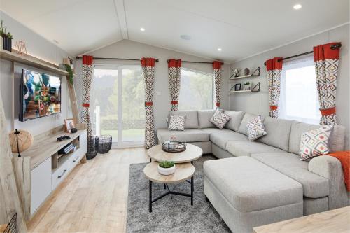a living room with a couch and a table at Elite Holiday Caravan in Bassenthwaite