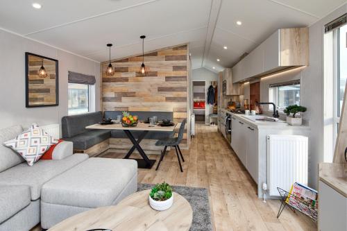 a living room and kitchen with a couch and a table at Elite Holiday Caravan in Bassenthwaite