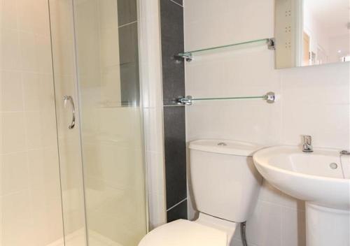 a bathroom with a shower and a toilet and a sink at Atlantic Retreat 10a Ventnor Terrace in St Ives