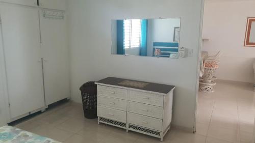 a room with a dresser and a mirror on the wall at Appartement à Louer à Boca Chica in Boca Chica