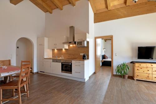 a kitchen with a table and a dining room at Appartementhaus Tanja in Ellmau