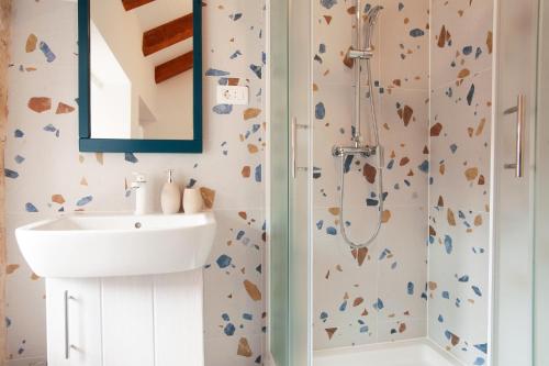 a bathroom with a sink and a shower at Sketches of Milna in Milna