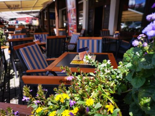 a table and chairs in a restaurant with flowers at Wellness Pension 7 in Harrachov