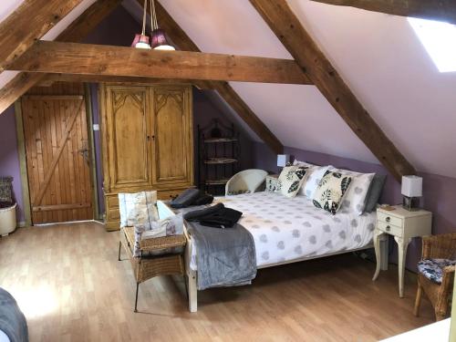 a bedroom with a bed in a attic at La forge b&b in Perret