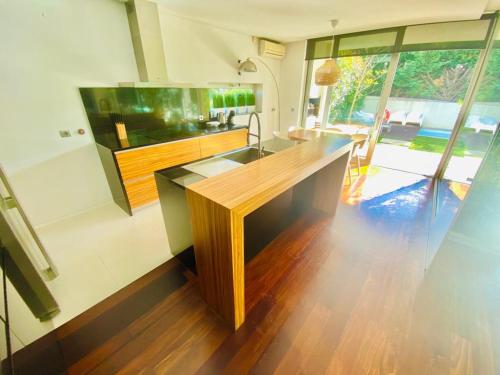 a kitchen with a wooden counter and a large aquarium at Portugal Holidays Villa in Barcelos