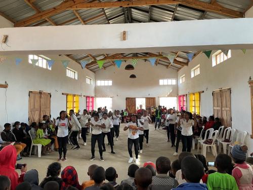 a group of people dancing in a room with a crowd at Hotel Ambalakely in Ambalakely