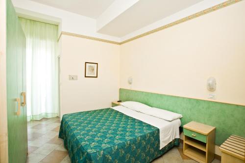 Postel nebo postele na pokoji v ubytování Hotel Giamaika