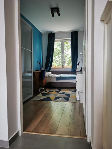 a room with a bedroom with a bed and a window at Comfortable apartment close to the center and sea in Gdańsk