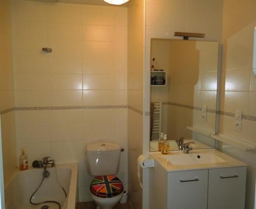 a bathroom with a sink and a toilet and a mirror at Marensines - Capbreton jolie villa mitoyenne sur grand jardinet et terrasse en bois in Capbreton