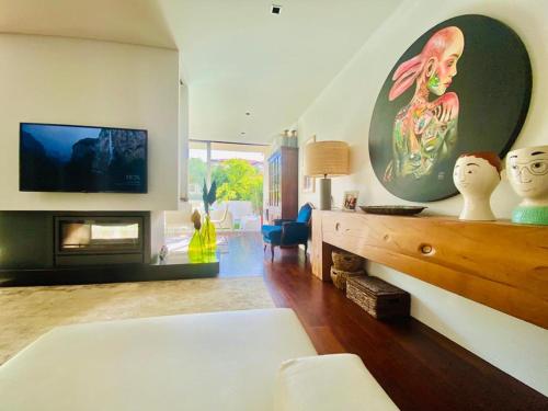 a living room with a fireplace and a flat screen tv at Portugal Holidays Villa in Barcelos