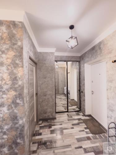a hallway with a tile floor and a ceiling at RentHouse Apartments Urban Lion in Chişinău