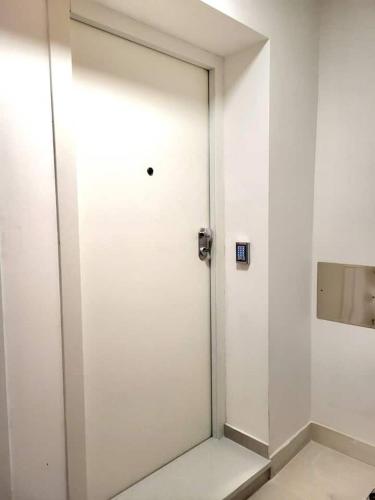 a white door in a white wall with a mirror at Apartments Sea Pearl in Makarska
