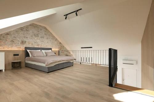 a bedroom with a large bed in a attic at Apartments Sea Pearl in Makarska
