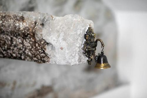 a metal bell is attached to a rock at Apartments Sea Pearl in Makarska