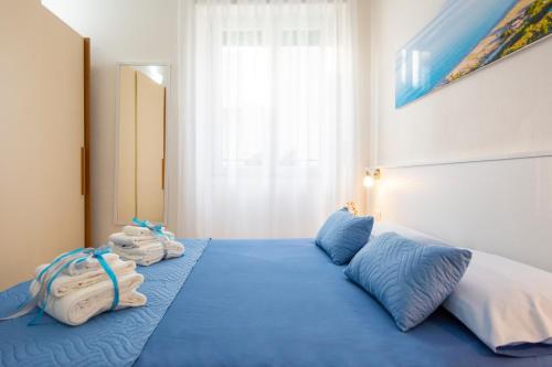 a bedroom with a blue bed with towels on it at Casa Mian - Bed and Breakfast in Orosei
