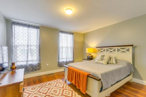 a bedroom with a bed and two windows at Cozy Maryland Abode - Gas Grill, Near Devils Den! in Emmitsburg