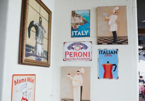 a wall with signs and pictures on it at Ocean Reef Suites in Miami Beach