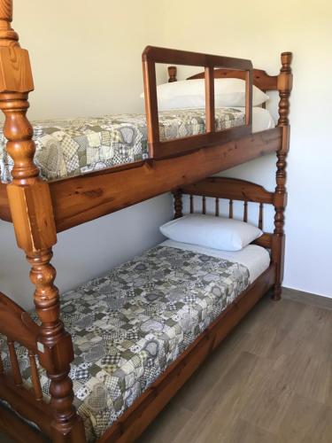 a bedroom with a bunk bed with a wooden frame at Agriturismo Poggio Ajano in Abbazia di Santa Maria in Selva