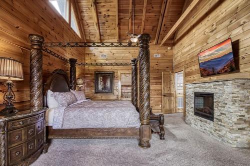 a bedroom with a bed and a fireplace in a cabin at Serenity Mountain Pool Lodge in Sevierville