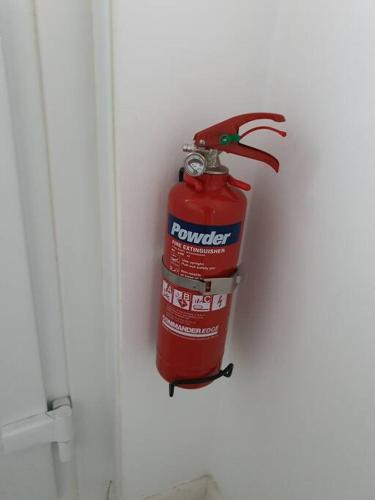 a red fire hydrant is hanging on a wall at Awave From It All - Escape the city life in Jaywick Sands