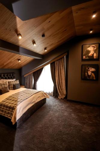 a bedroom with a large bed and a large window at Kashmir Wellness & SPA Hotel Adults Only in Velingrad
